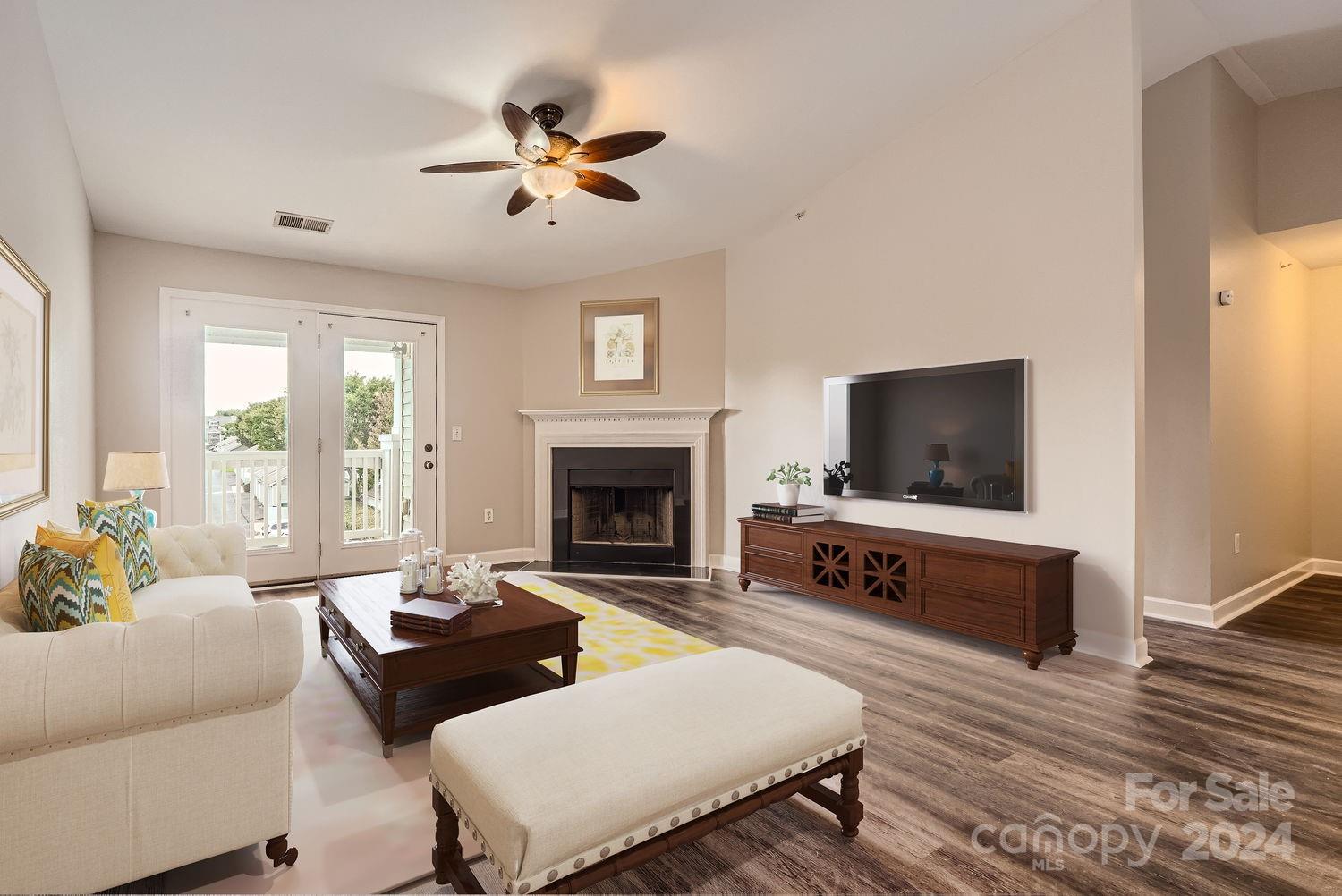 a living room with furniture a flat screen tv and a fireplace