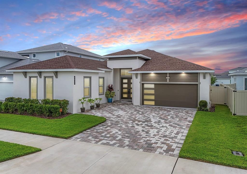 a front view of a house with a yard and garage