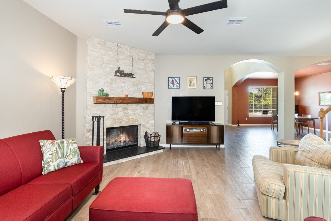 a living room with furniture a flat screen tv and a fireplace