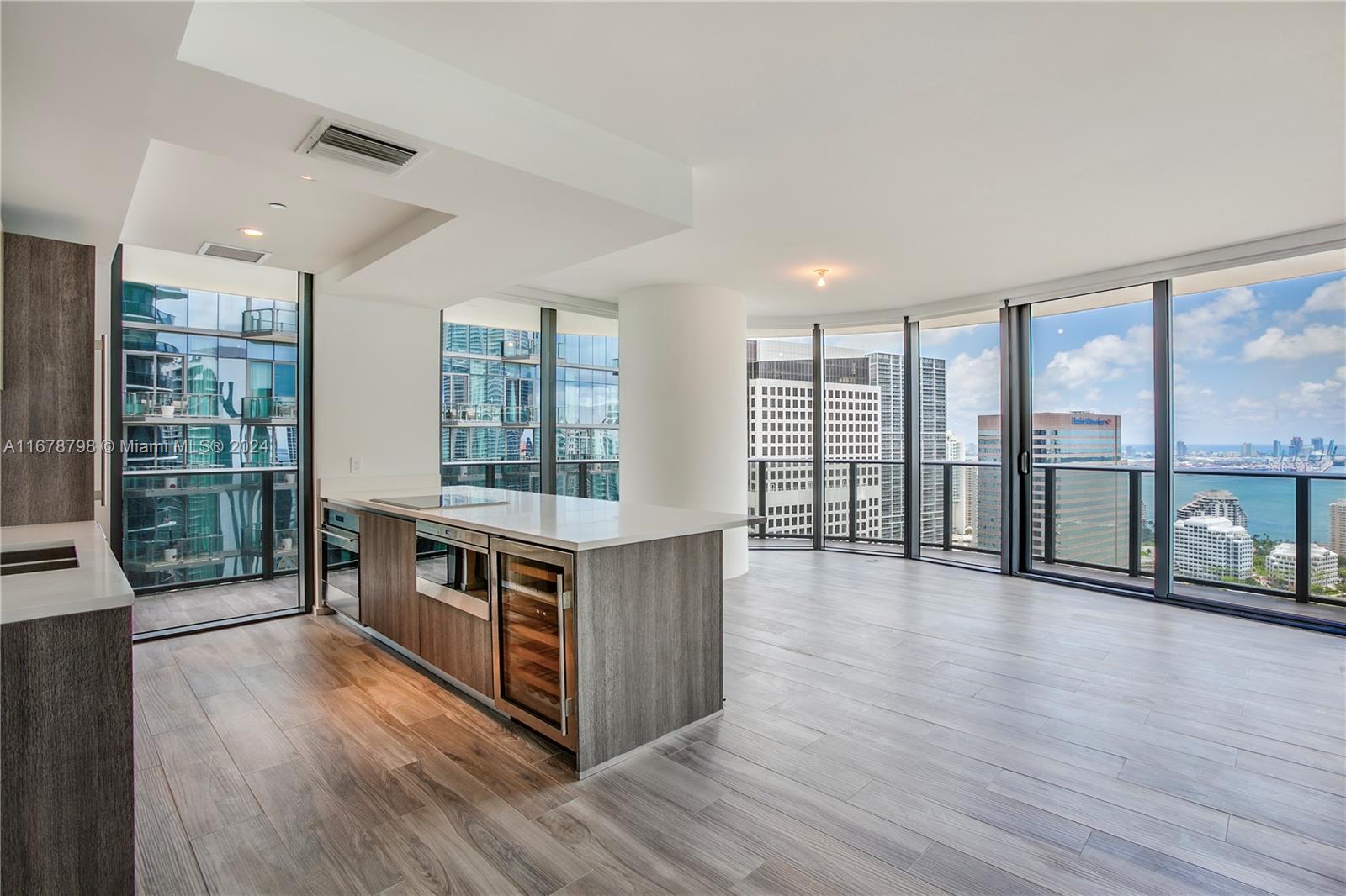 a view of kitchen with stainless steel appliances granite countertop a stove and a large window