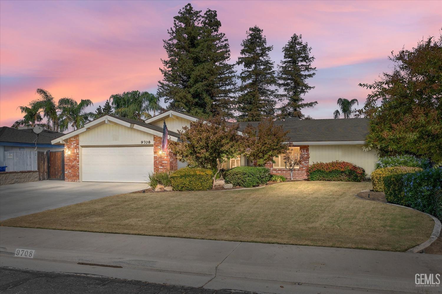 a view of a house with a yard and garage