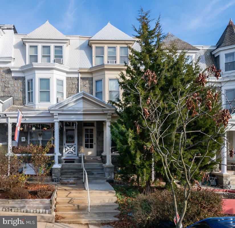 a front view of a residential apartment building with a yard