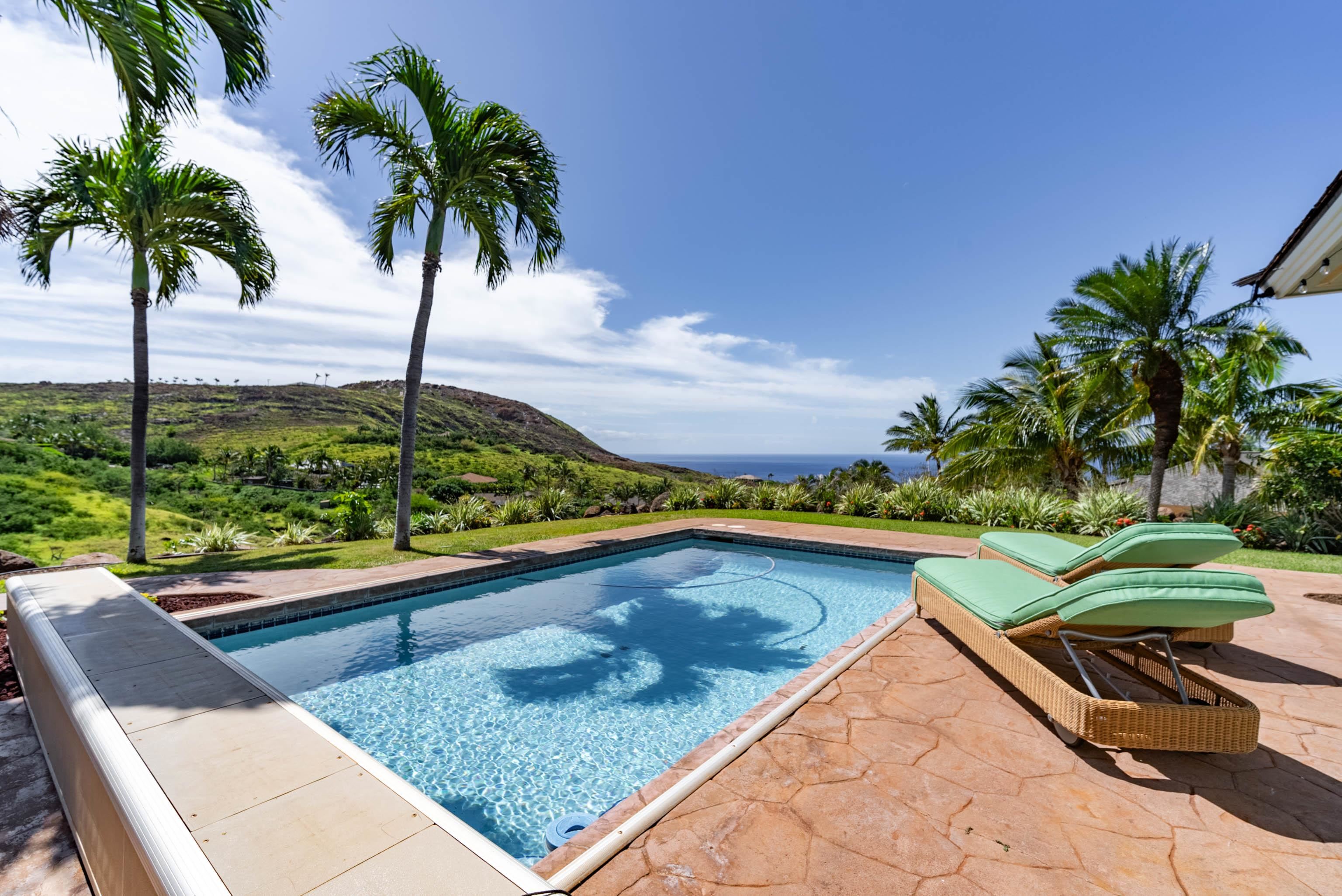 a view of swimming pool with a lounge chairs