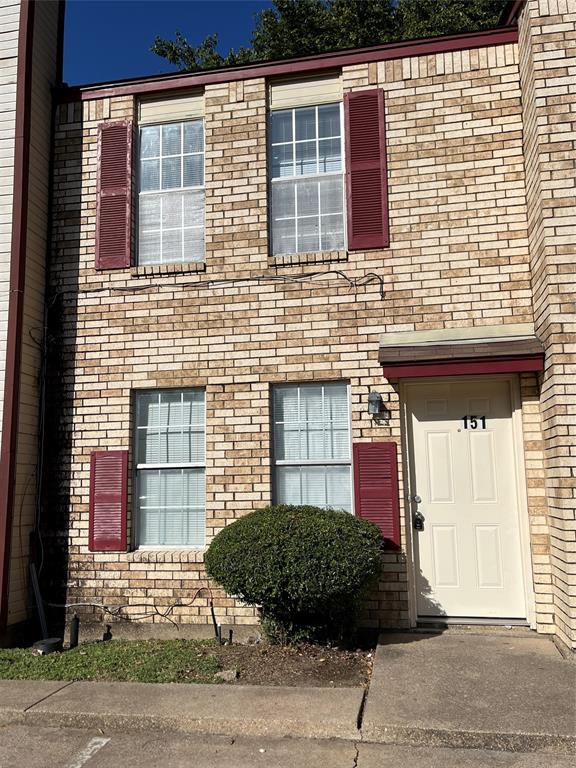 a view of a brick house with many windows