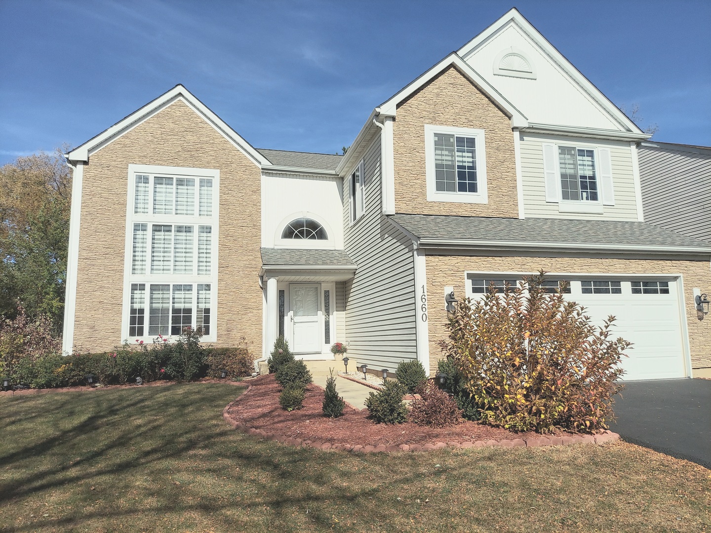 a front view of a house with a yard