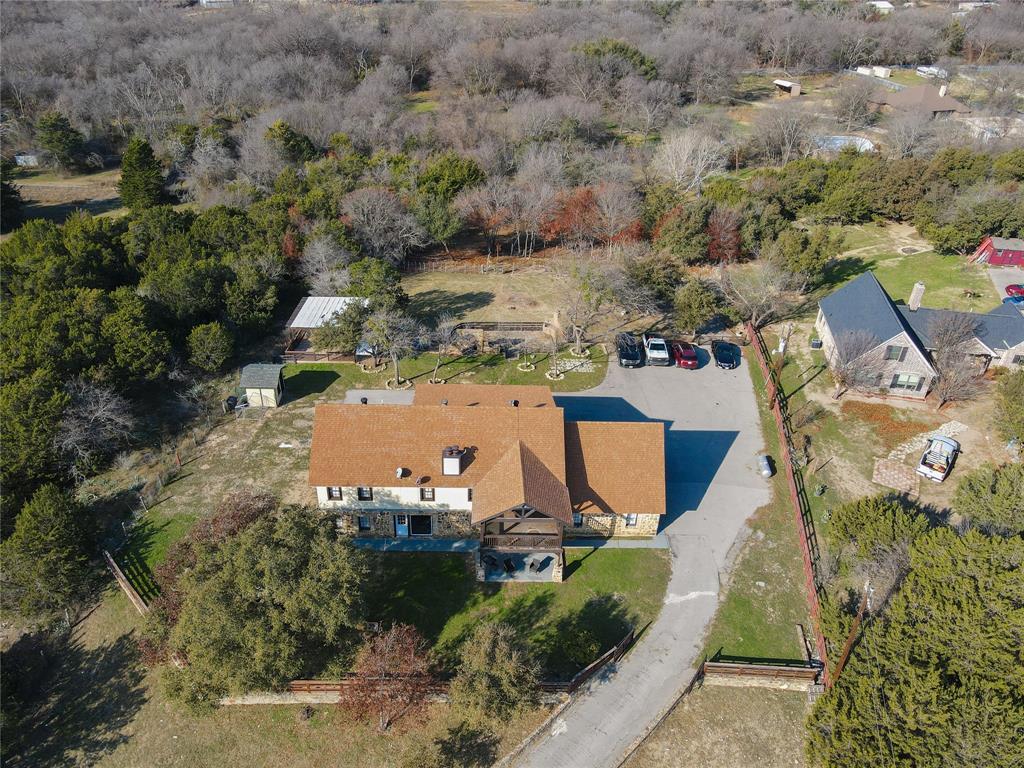 an aerial view of a house with a yard