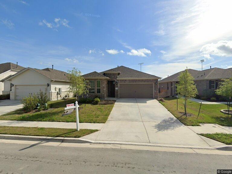 a front view of house with a garden