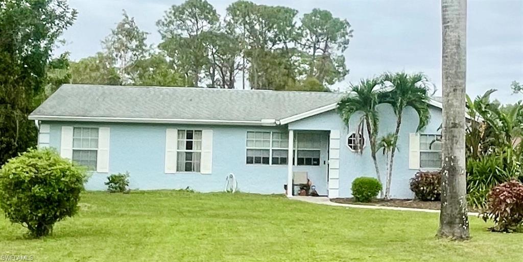 a view of a house with a yard and plants