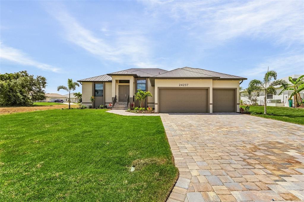 a front view of a house with a yard and garage