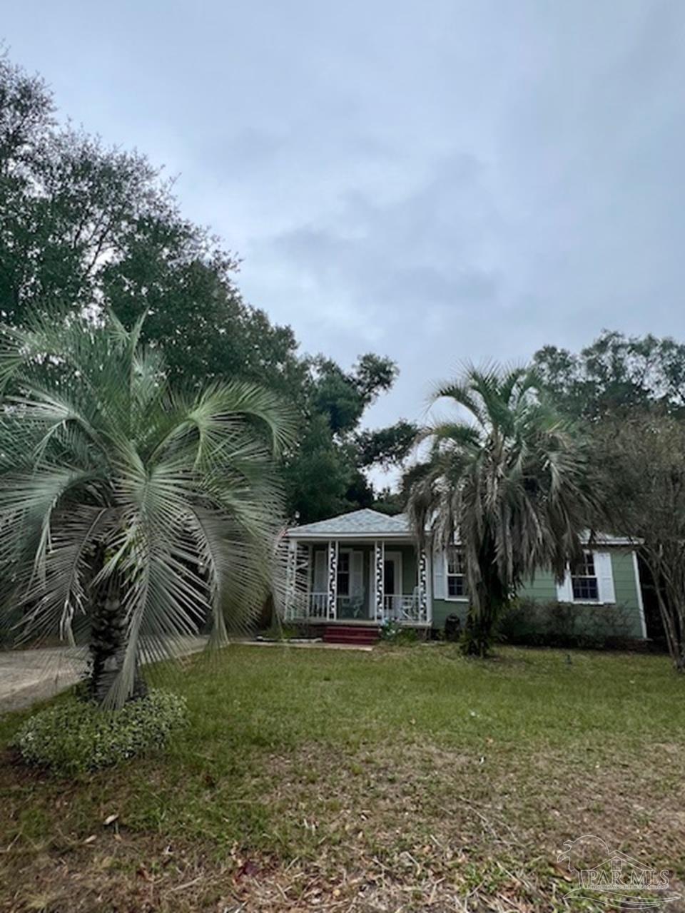 a front view of a house with a garden