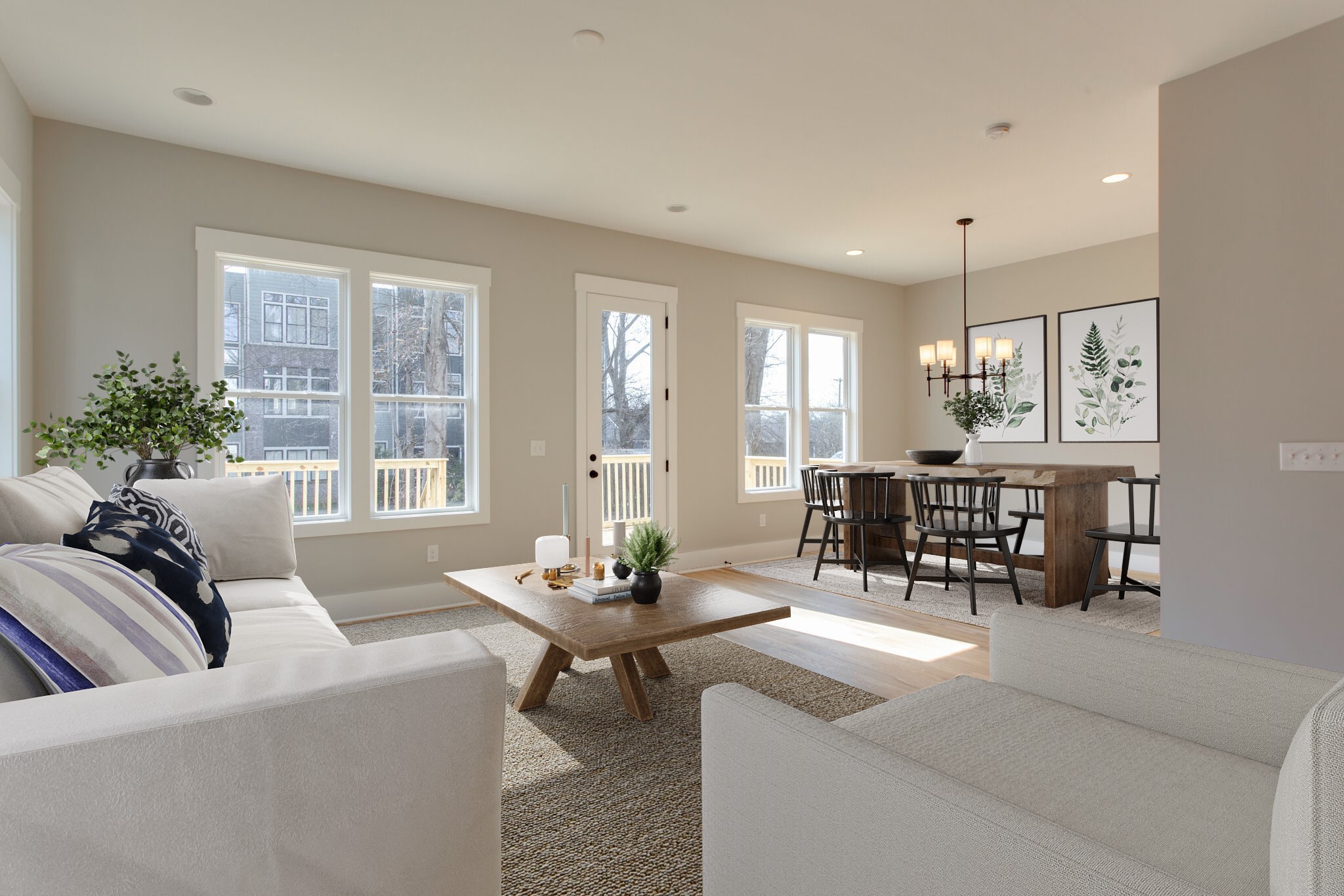 a living room with furniture and potted plants