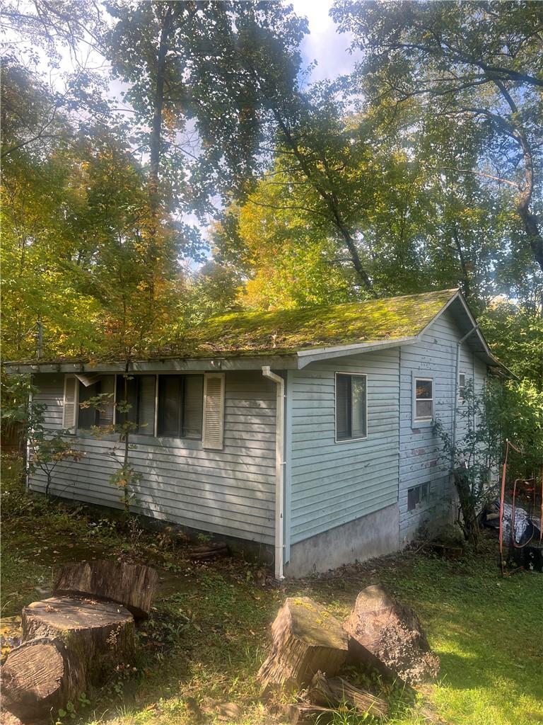 View of side of property with a yard