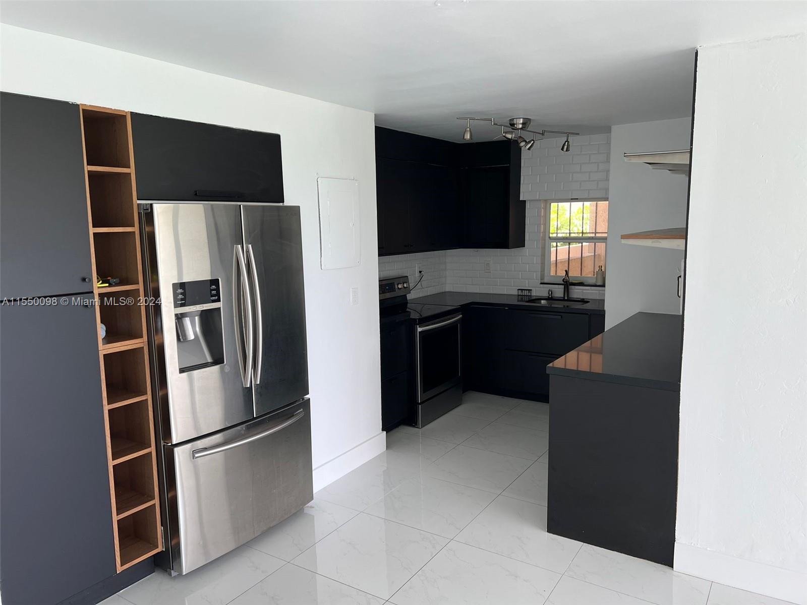 a kitchen with a refrigerator and a sink