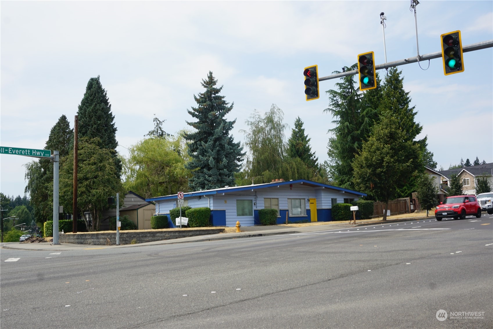 a view of street with a car parked on the road