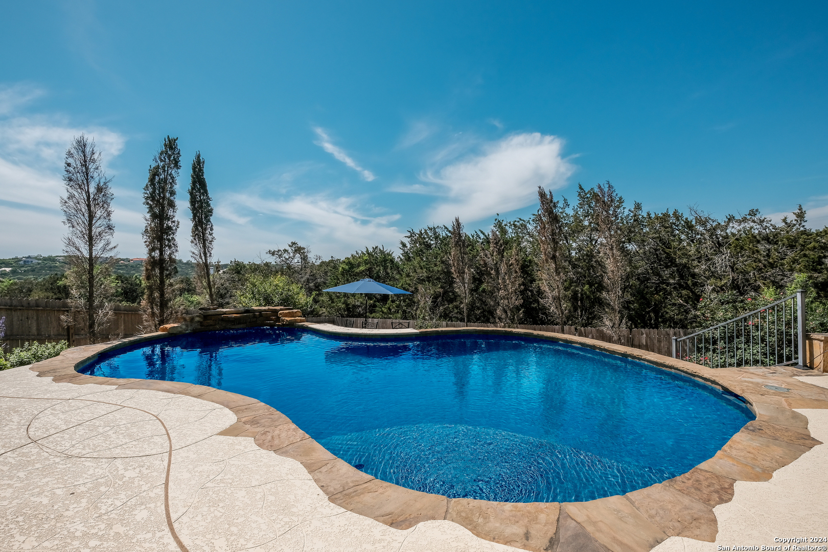 a view of a swimming pool with a lounge chair