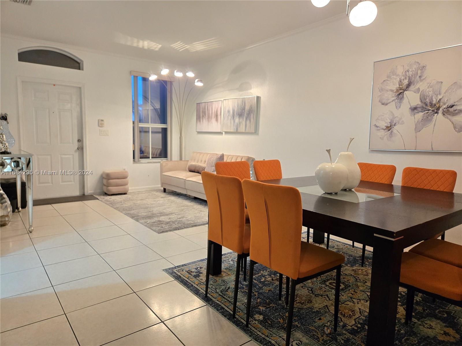 a view of a dining room with furniture and a chandelier