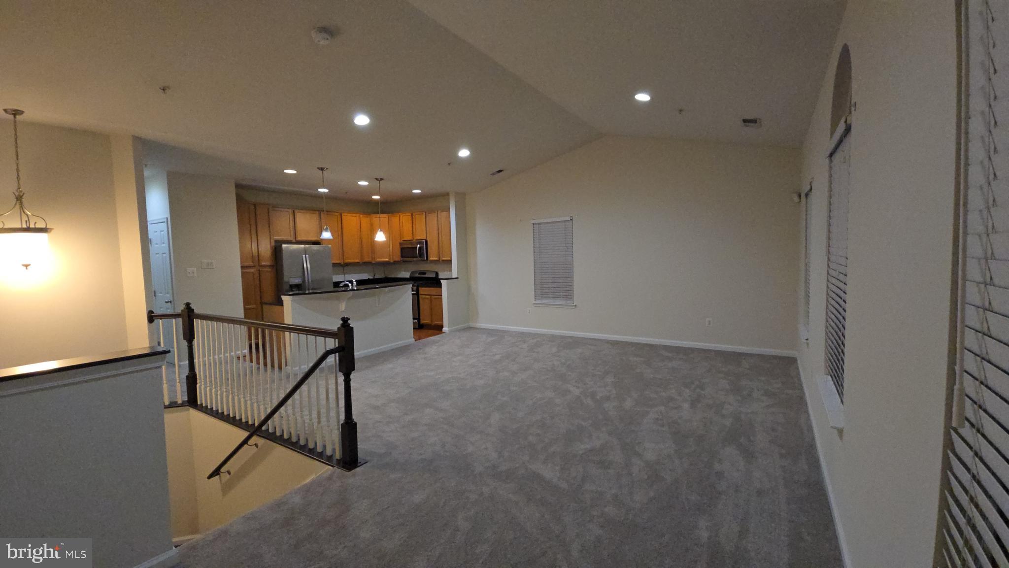 a view of a livingroom with furniture and a ceiling fan