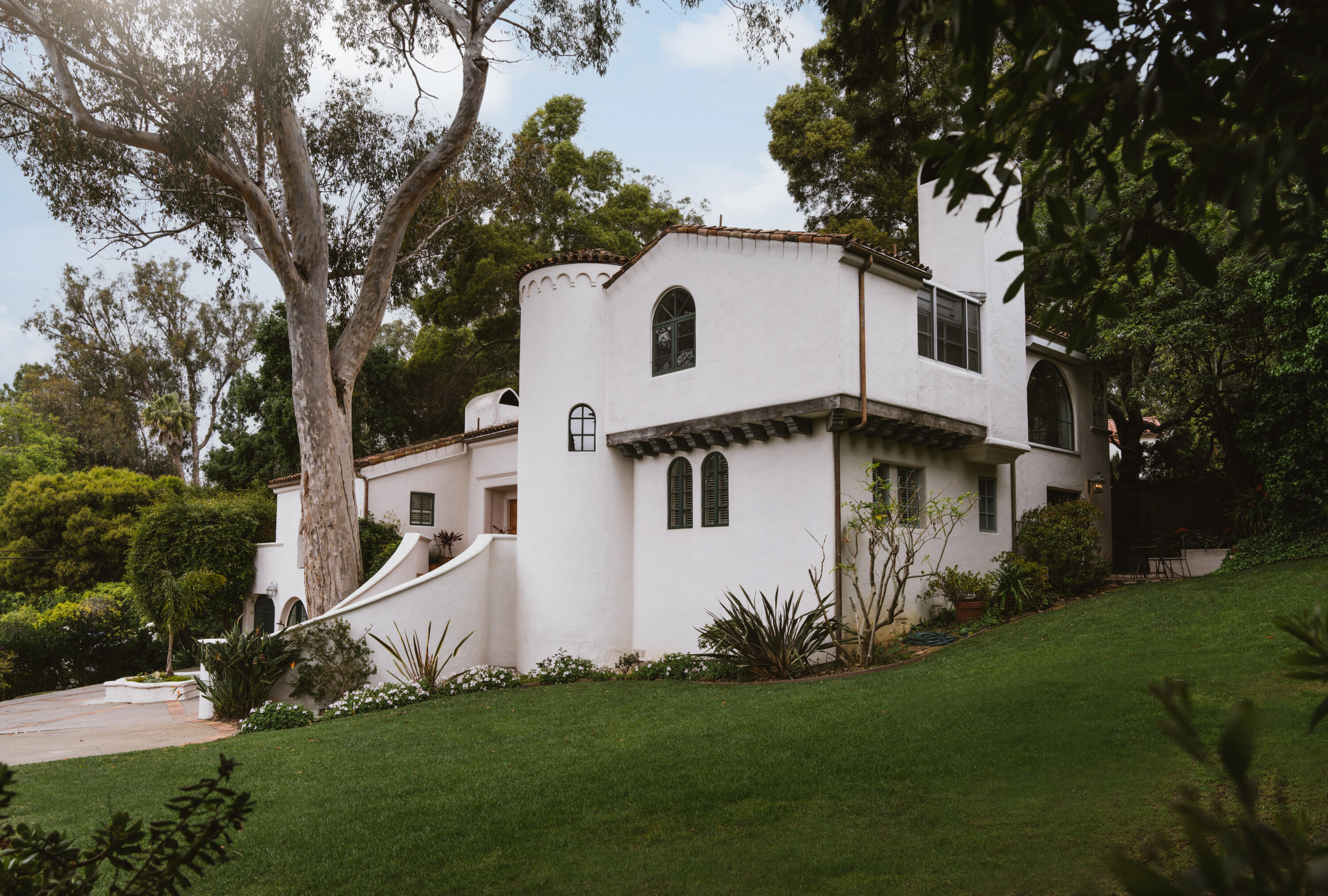 a front view of a house with a garden