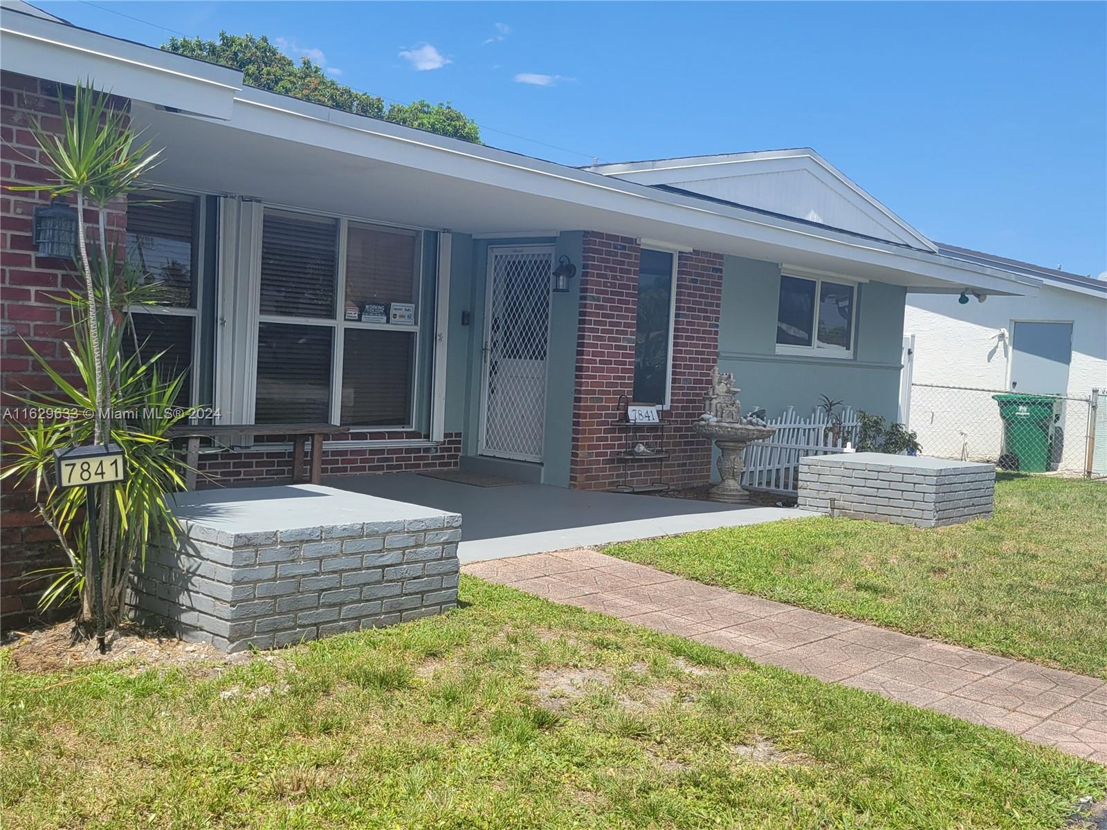 a front view of house with yard and outdoor seating