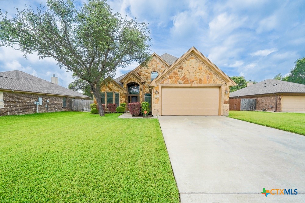 a front view of house with yard and green space