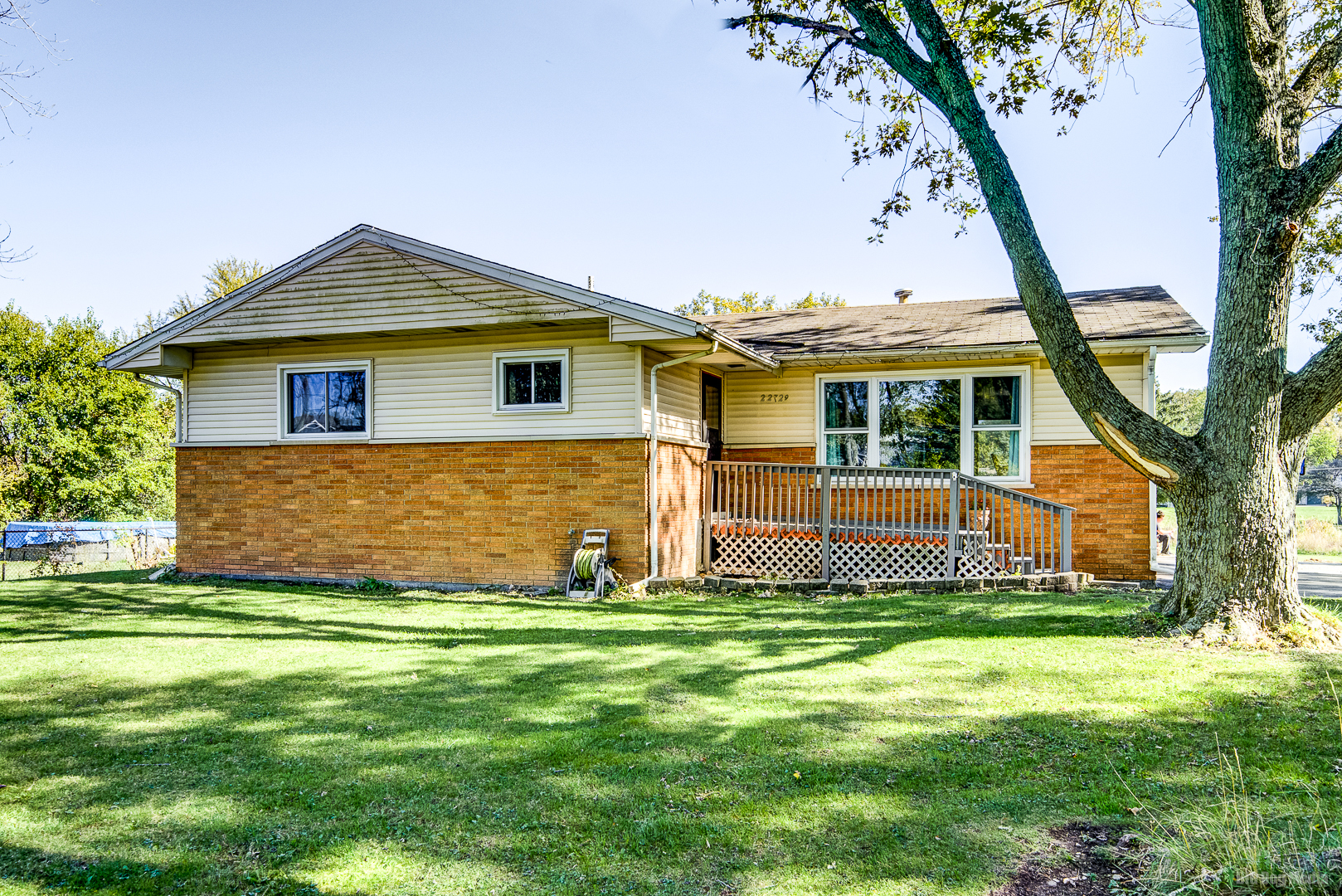 a front view of house with yard and green space