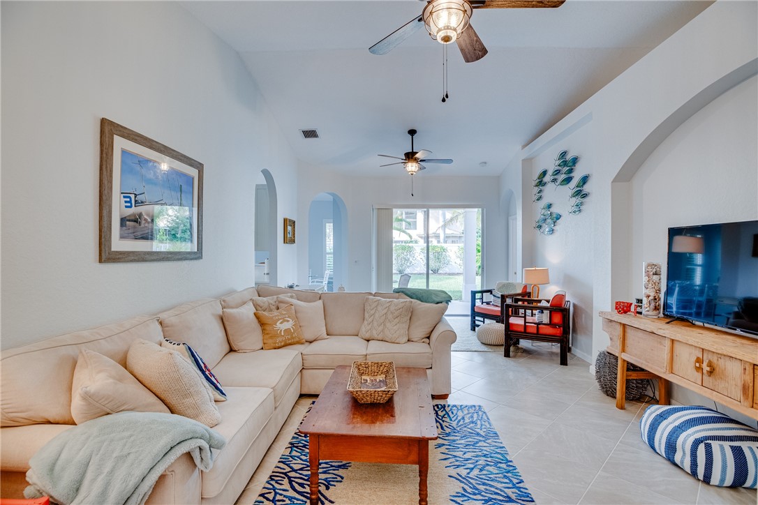 a living room with furniture fireplace and a window