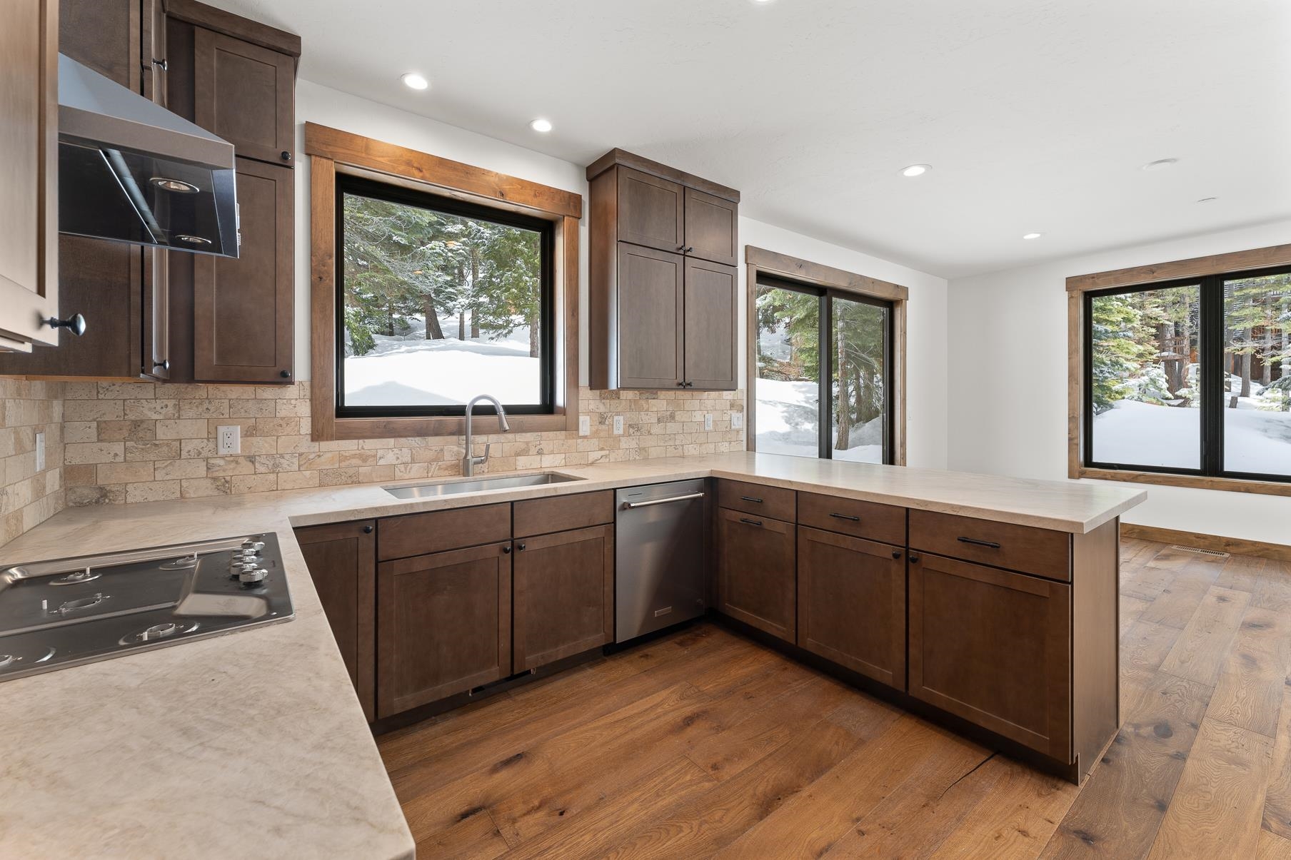 a large kitchen with wooden cabinets and a granite counter tops