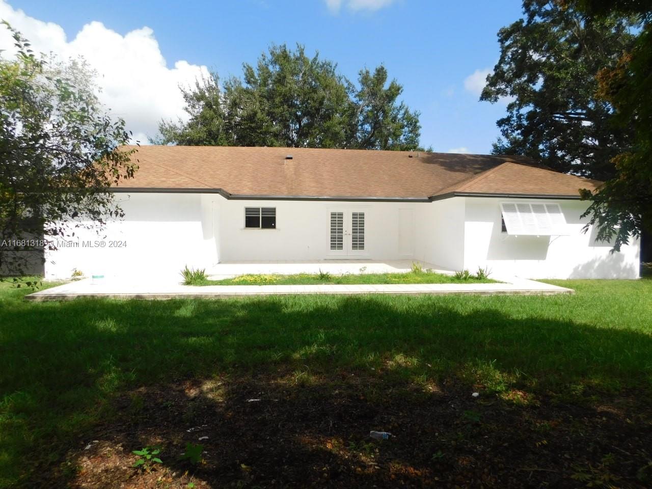 a view of house with backyard