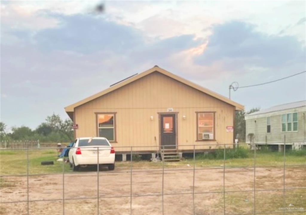 a view of a house with a backyard