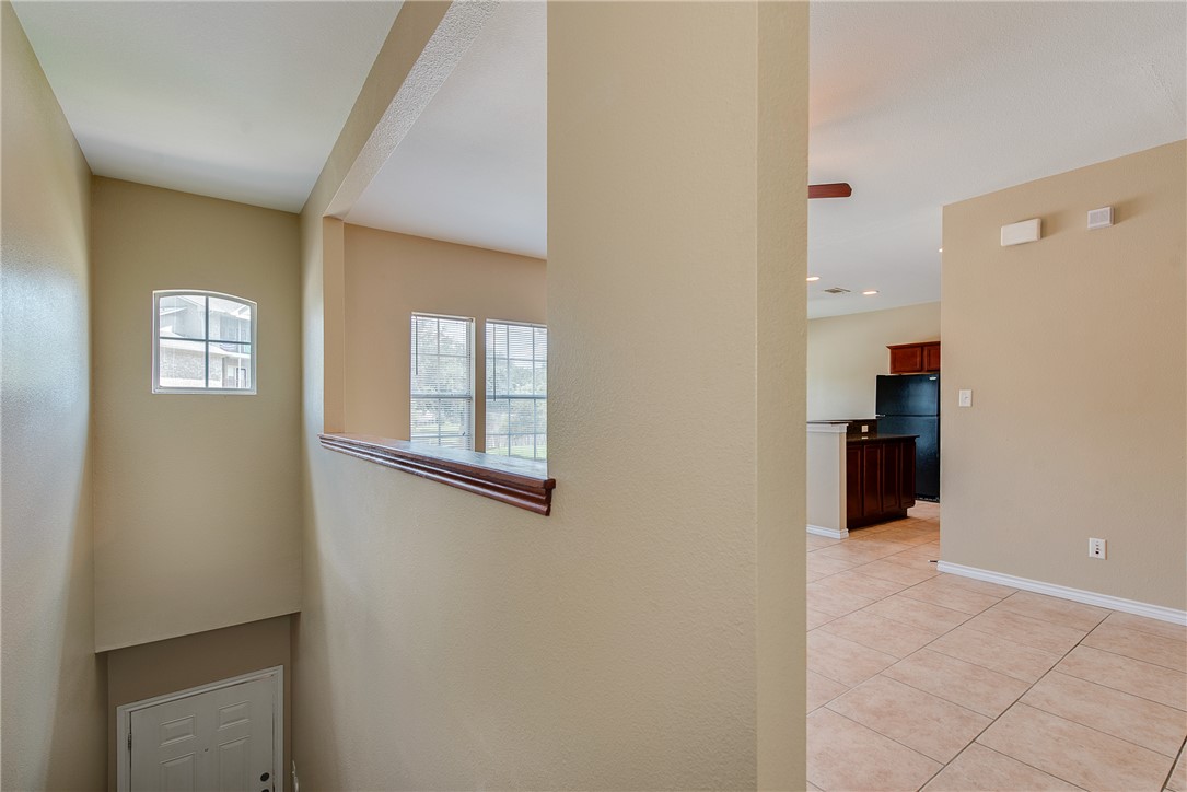 a view of an empty room with closet and a window