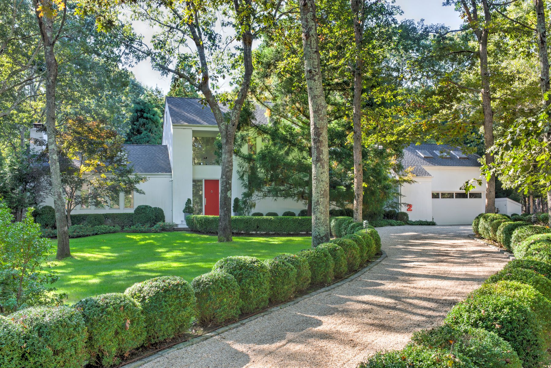 a front view of a house with garden