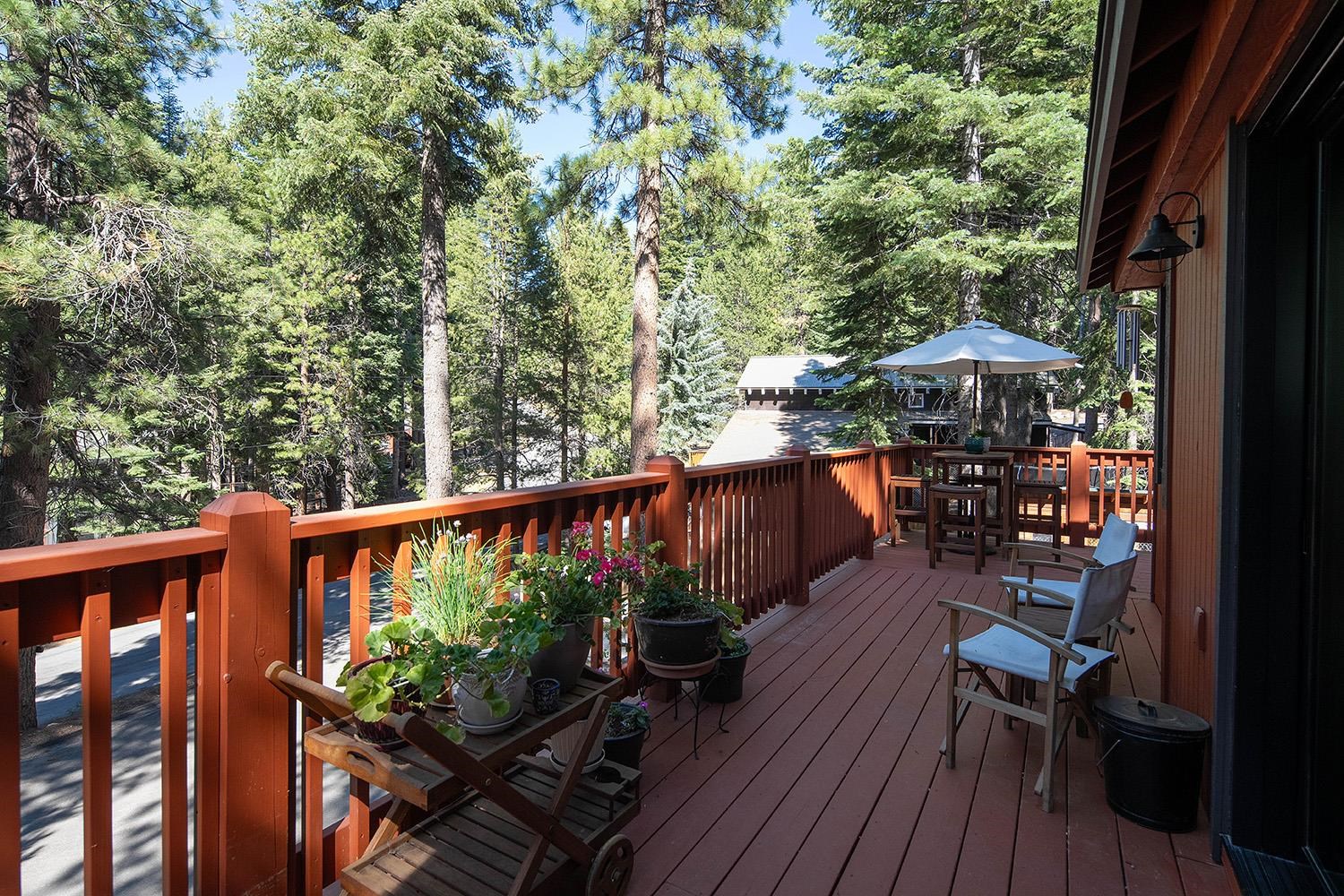 a balcony with wooden floor and outdoor seating