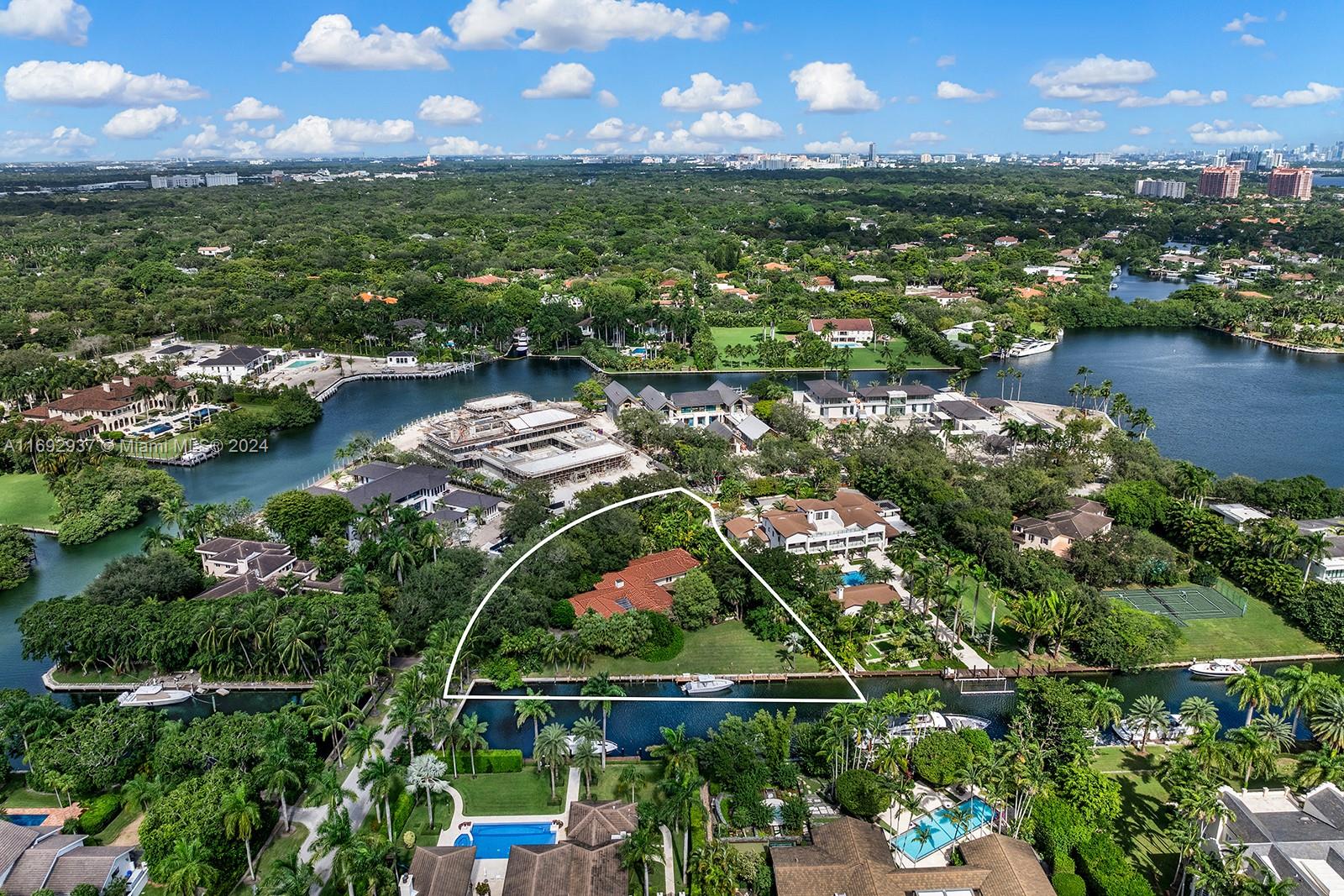 an aerial view of residential houses with outdoor space and lake view