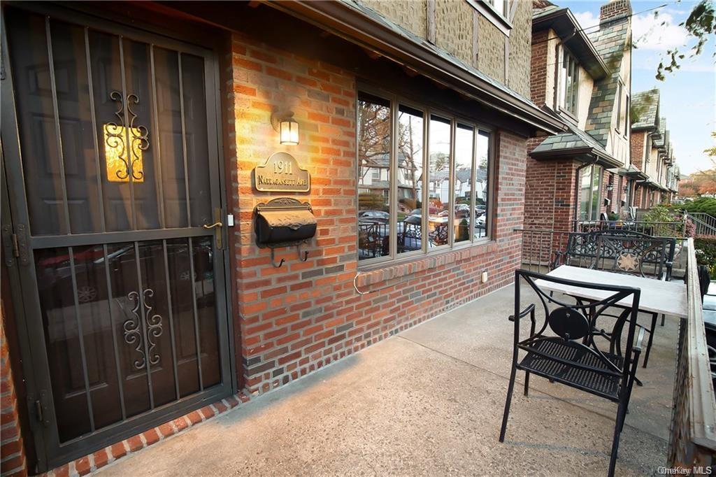 a balcony with table and chairs