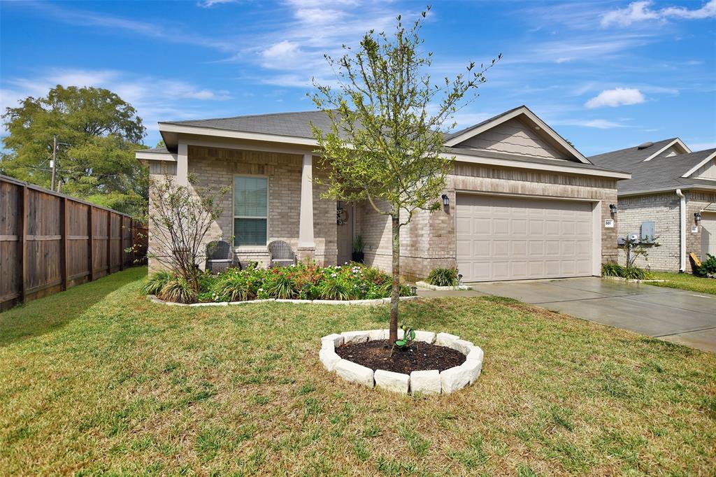 a front view of house with yard and green space