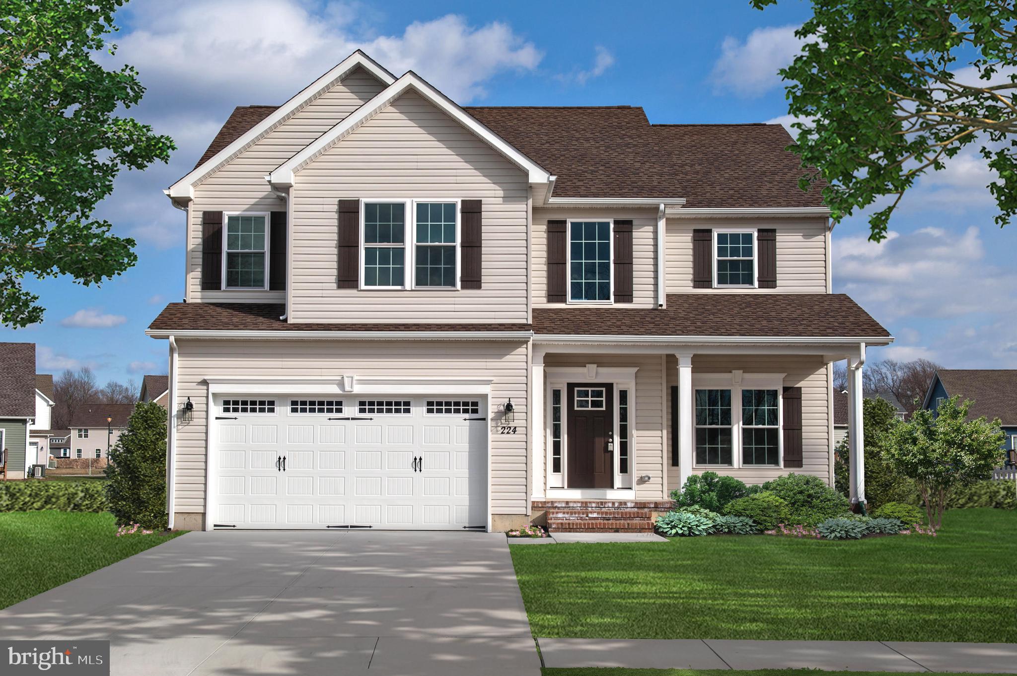 a front view of a house with a yard and trees