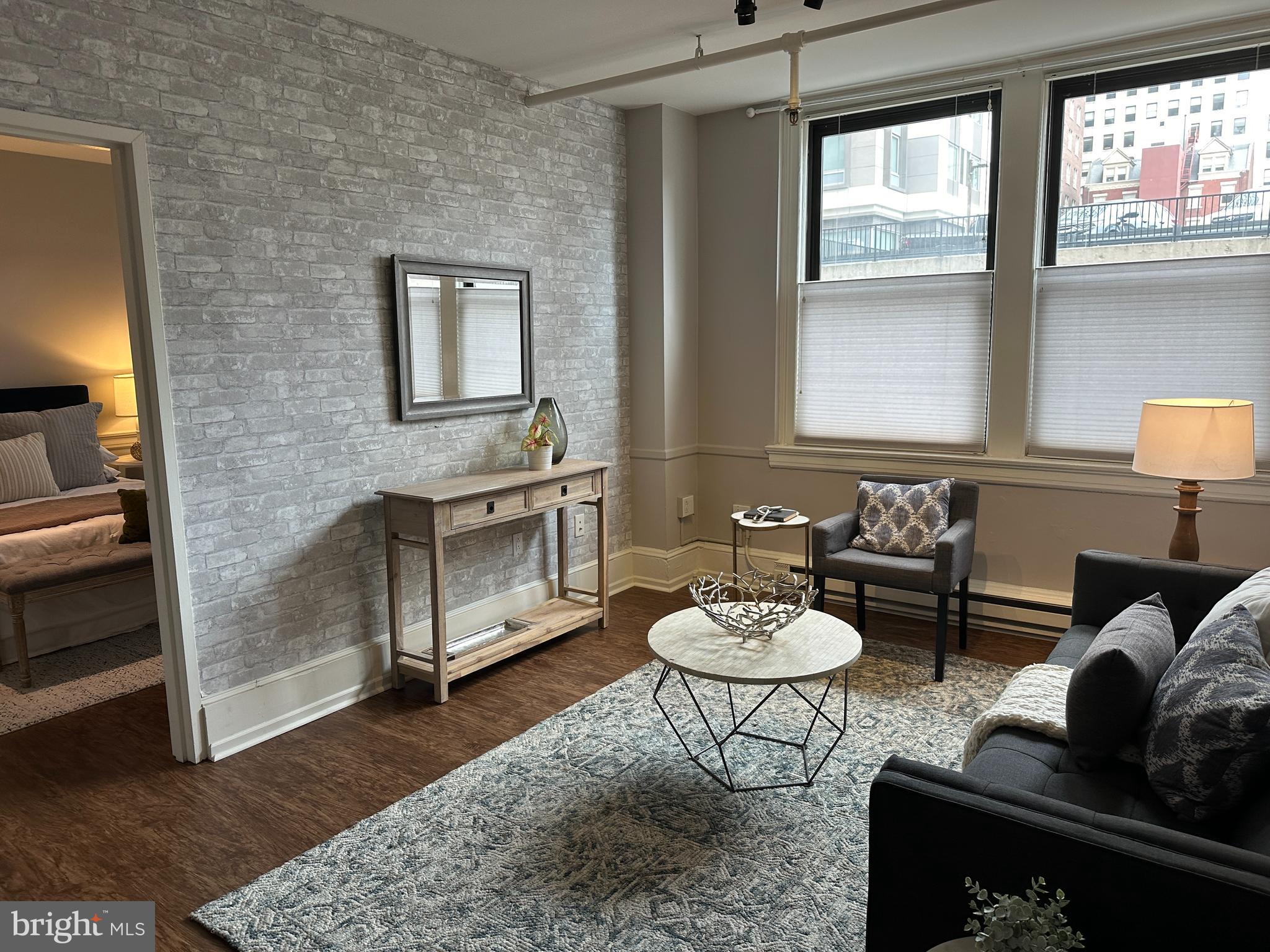 a living room with furniture a window and a fireplace