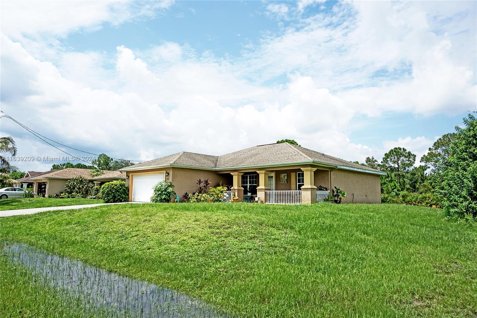 a front view of a house with a garden