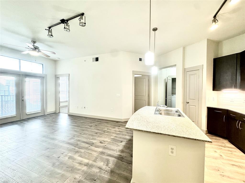 a large kitchen with kitchen island a sink stainless steel appliances and cabinets