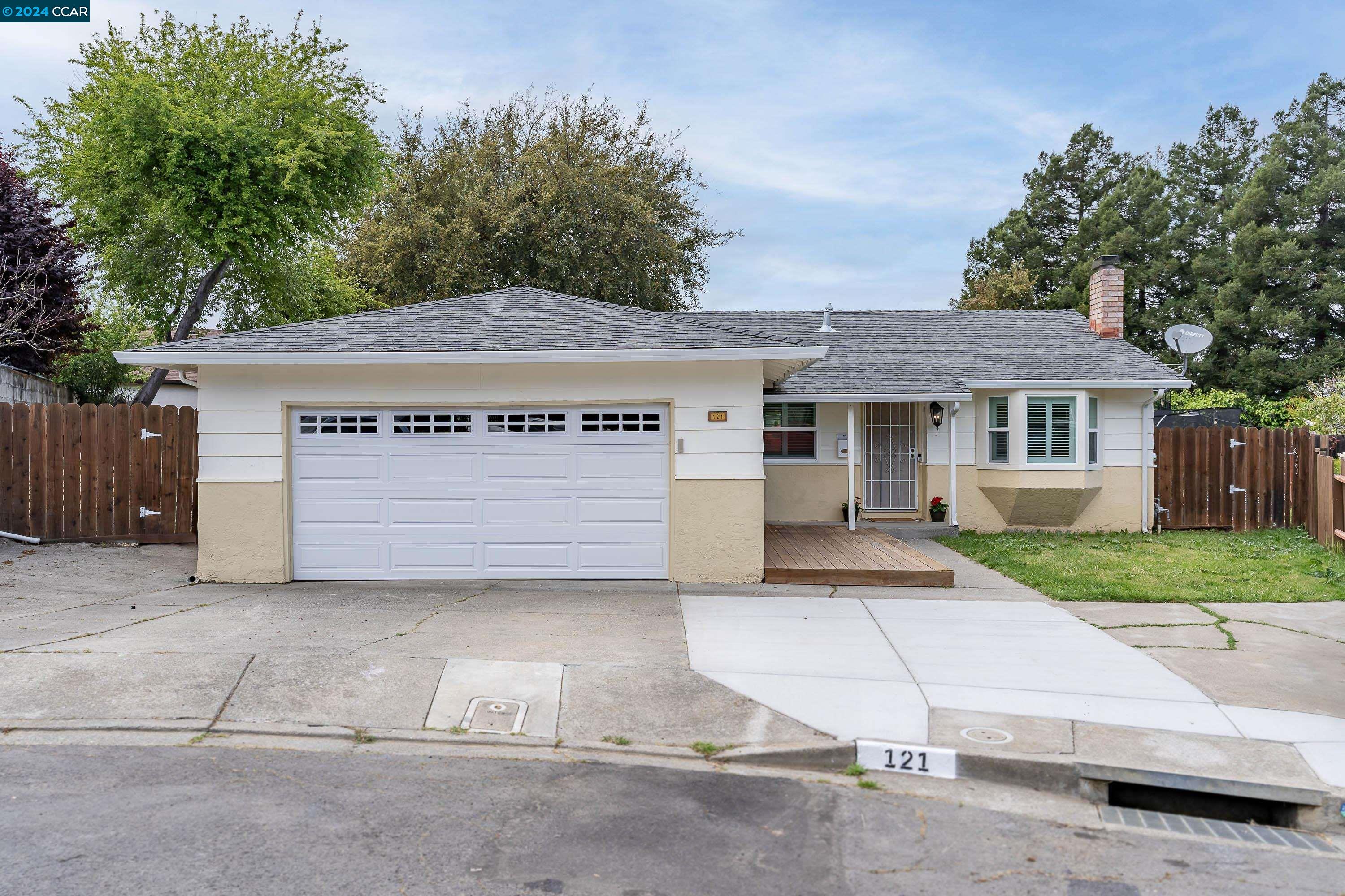 a view of a house with a yard and garage