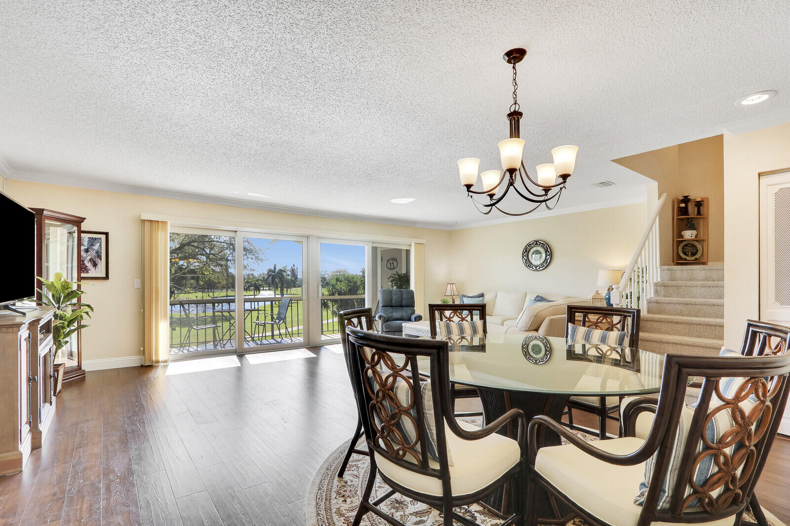 a view of a dining room with furniture wooden floor and chandelier