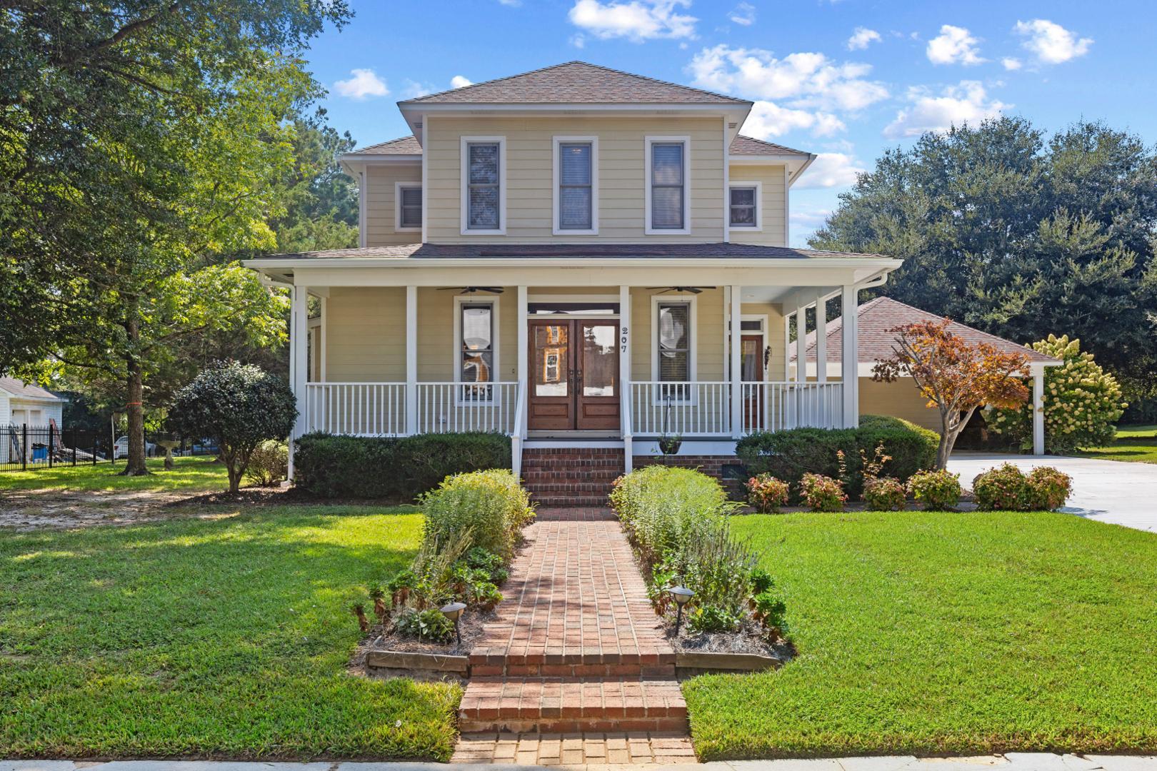 a front view of a house with garden