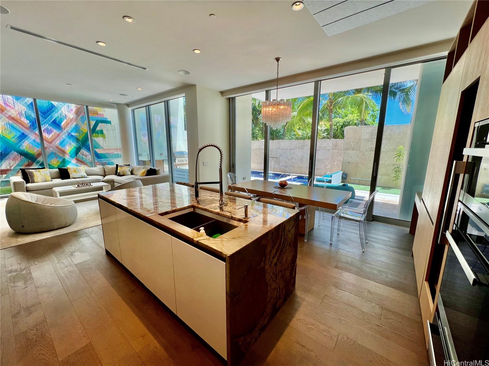 a kitchen with stainless steel appliances a sink a counter top space and a large window