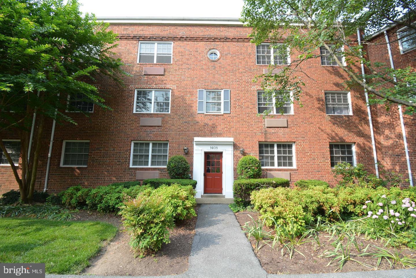 front view of a brick house with a yard