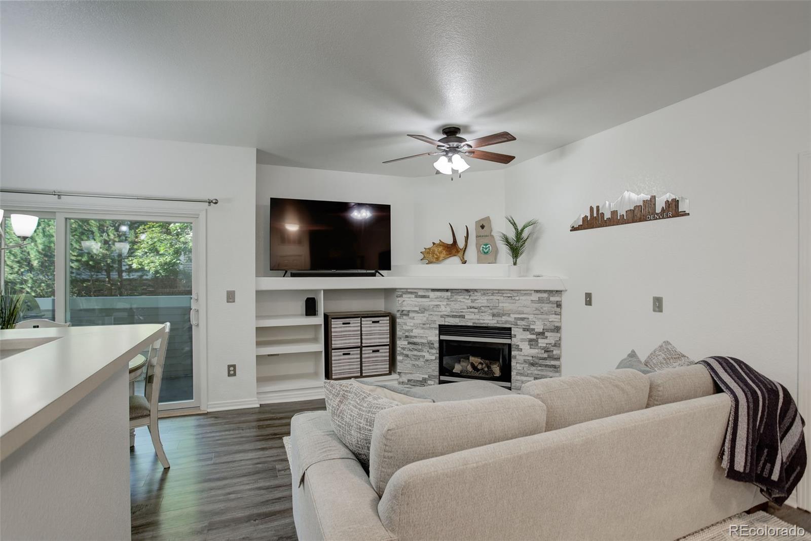 a living room with furniture fireplace and flat screen tv