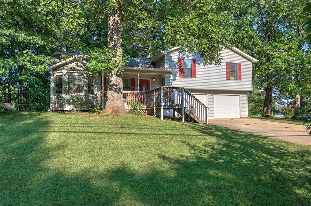 a view of a house with a yard and sitting area