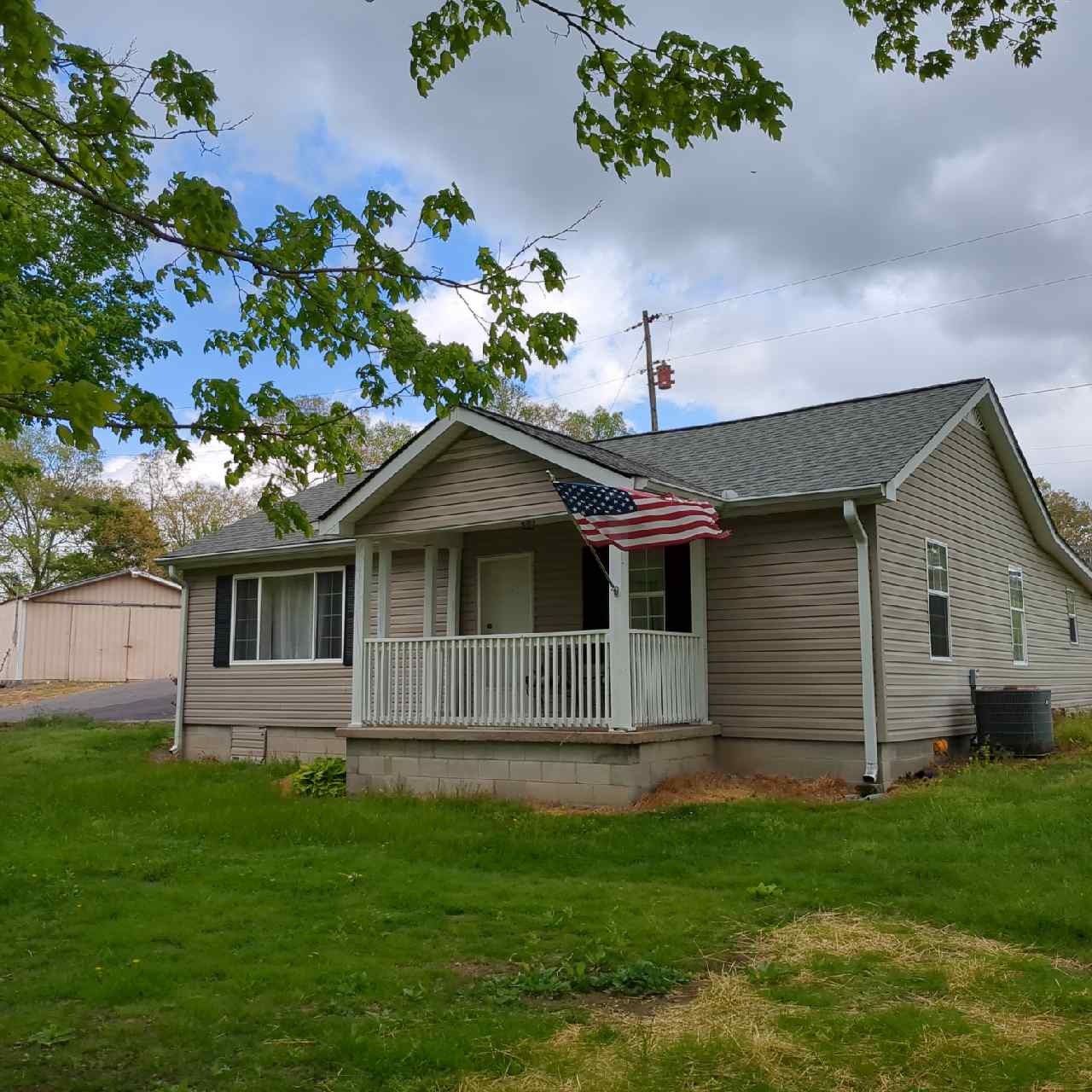 a front view of a house with a garden