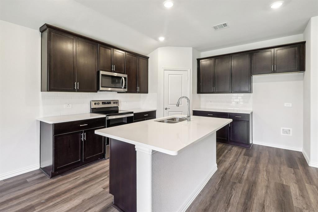 a kitchen with a sink and cabinets