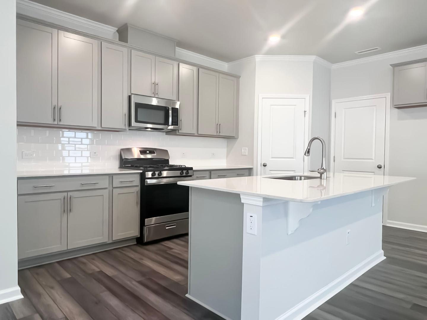 a kitchen with a sink stove and cabinets