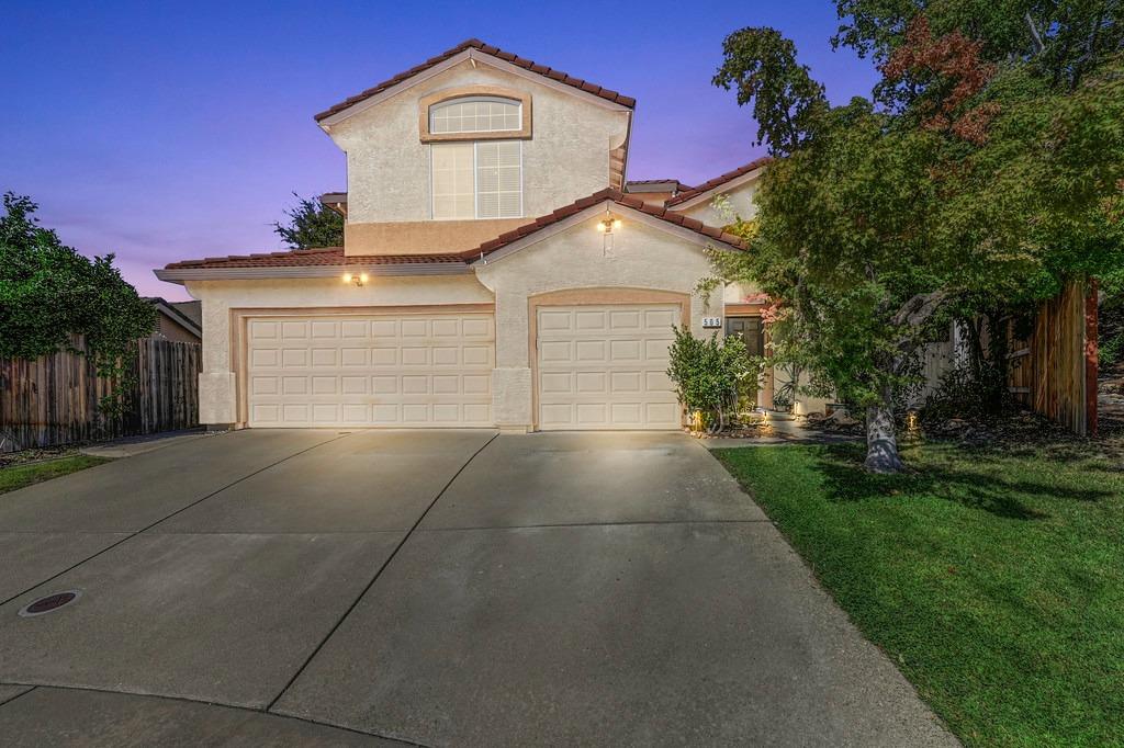 a front view of a house with a yard and garage